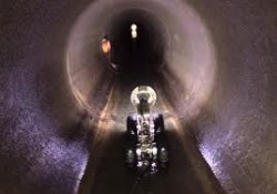 CCTV crawler camera travelling through a large sewer pipe