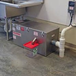 Installed grease trap with enzyme dosing unit