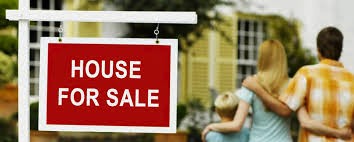 Family outside a house with a For Sale sign